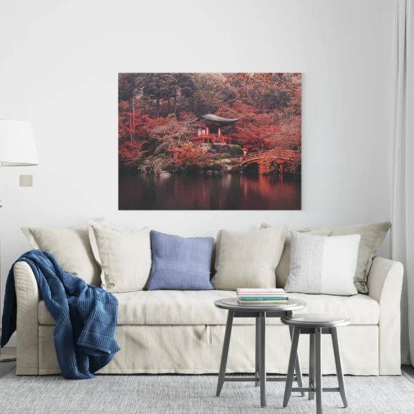 A serene Japanese autumn landscape with a red temple and bridge over a tranquil pond.